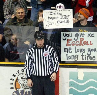 hockey-game-referee-humorous-fan-holding-sign-biggest-idiot-ever.jpg